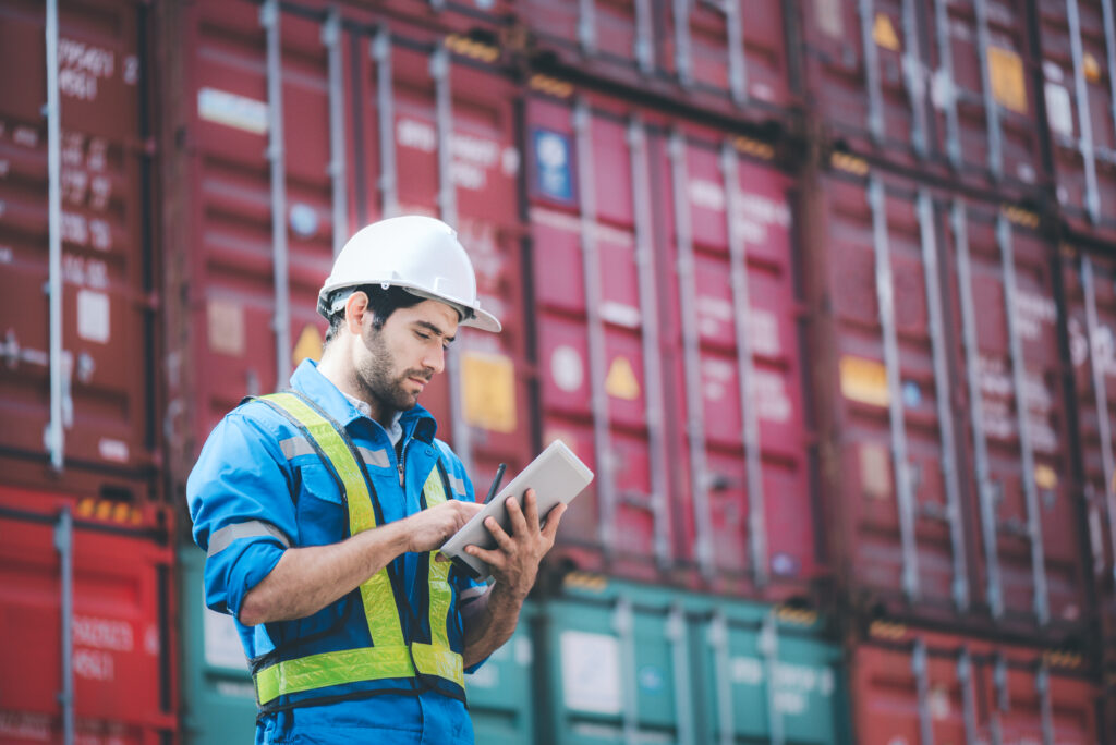 Ocean Port Worker tracks shipping containers on his ipad