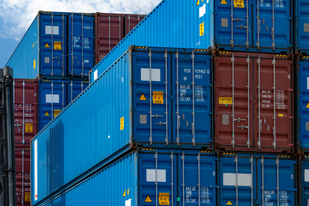 Shipping container drayage and transloading. Stacked at east coast port or west coast port